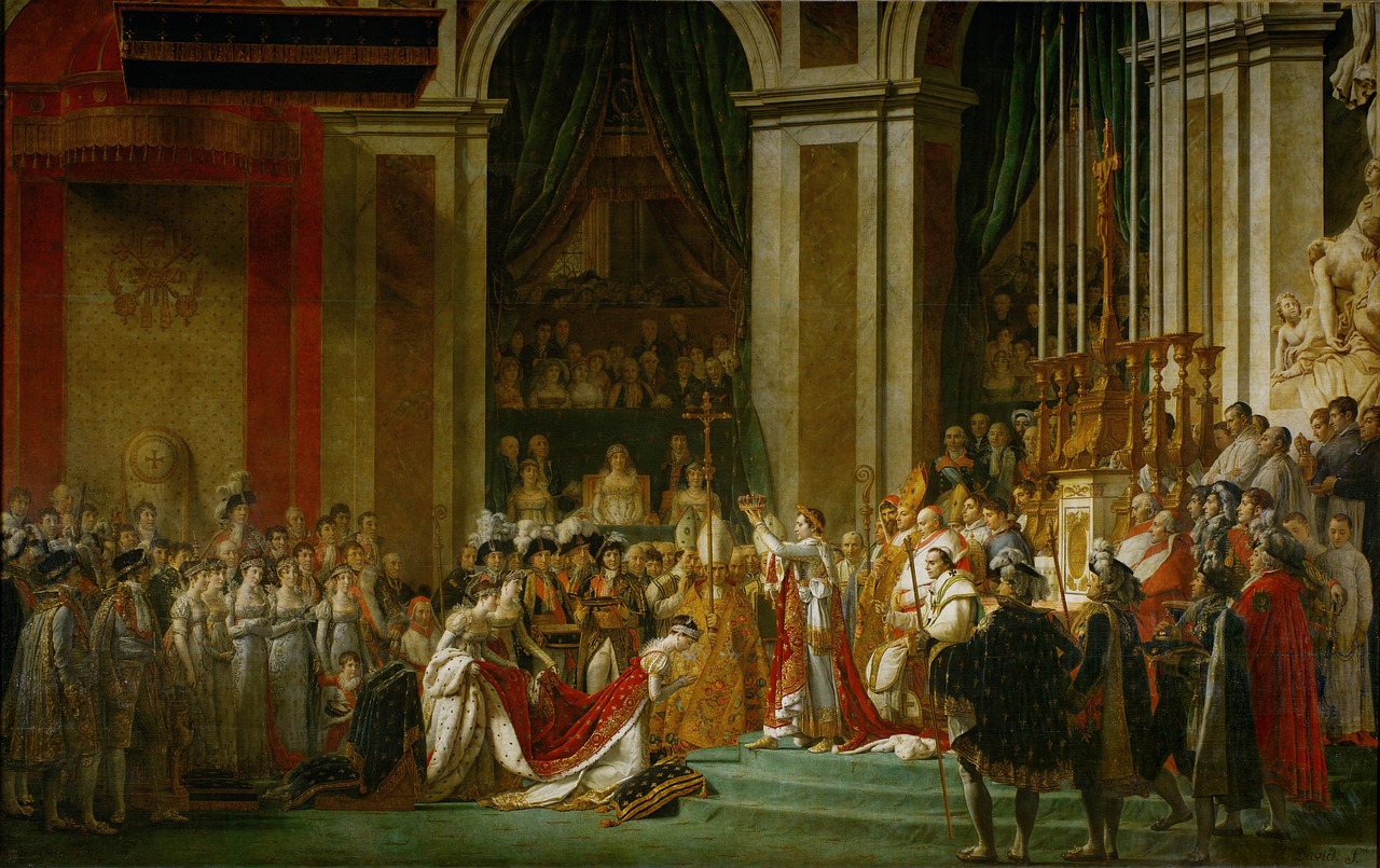 The image is an artwork by Jacques-Louis David and is a depiction of Napoleon Bonapartes and empress Joséphines coronation in 1804, surrounded by the royal court